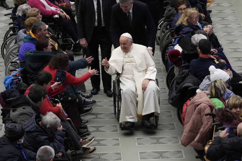 Pope Francis leaves after an audience with sick people and Lourdes pilgrimage operators in the Paul VI Hall, at the Vatican, Thursday, Dec. 14, 2023. (AP Photo/Alessandra Tarantino)