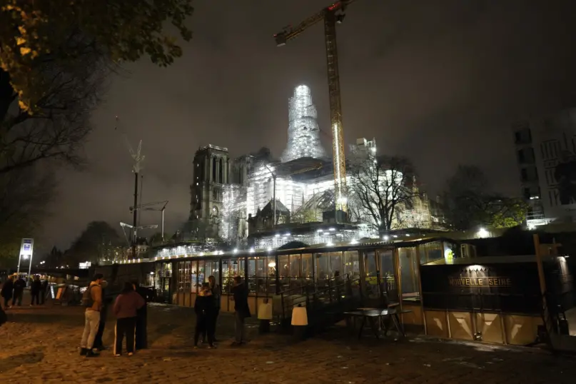 Notre-Dame de Paris cathedral is seen with its spire surrounded by scaffolding Tuesday, Dec. 5, 2023 in Paris. (AP Photo/ Thibault Camus)