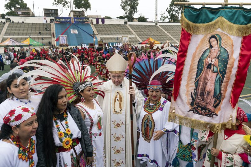 Archbishop of Los Angeles Jose H. Gomez stands with people celebrating the Virgin of Guadalupe's feast day in 2022. (AP Photo/Damian Dovarganes)