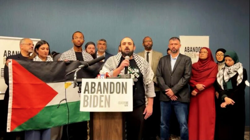 In this image taken from video, Muslim community leaders from several swing states pledge to withdraw support for US President Joe Biden, Dec. 2, 2023, at a conference in Dearborn, Michigan, citing his refusal to call for a cease-fire in Gaza. (Video screen grab/#AbandonBiden)