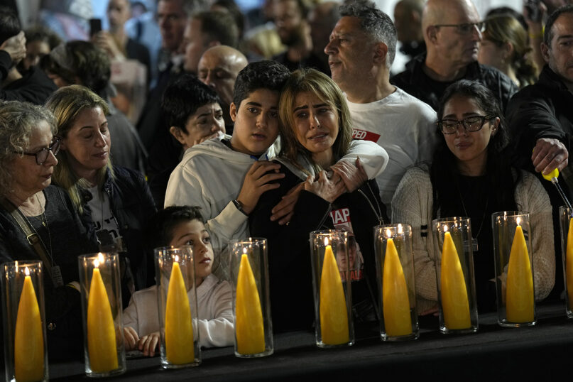 Relatives and friends of hostages held in the Gaza Strip by Hamas call for their release during the Jewish holiday of Hanukkah in the Hostages Square at the Museum of Art in Tel Aviv, Israel, Dec. 7, 2023. (AP Photo/Ariel Schalit)