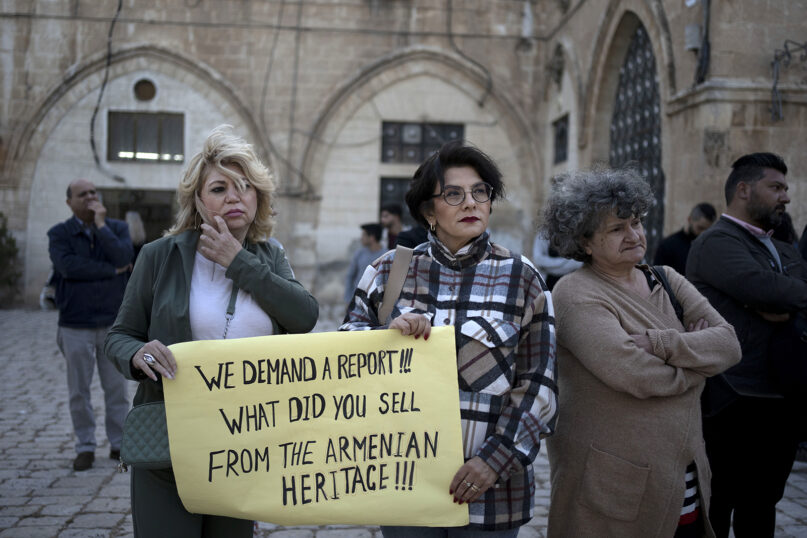Members of the Armenian community protest a contentious deal that stands to displace residents and hand over a large section of the Armenian Quarter in the Old City of Jerusalem, Friday, May 19, 2023. (AP Photo/Maya Alleruzzo)