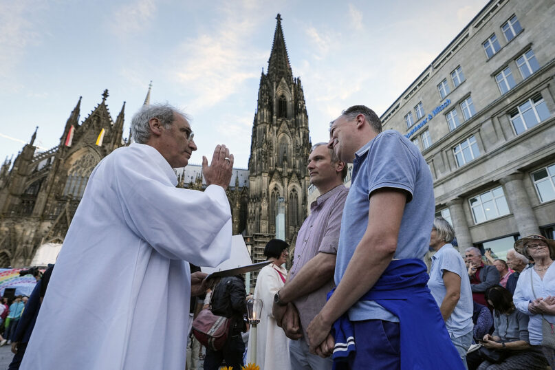FILE - Same-sex couples take part in a public blessing ceremony in front of the Cologne Cathedral in Cologne, Germany, on Sept. 20, 2023. Pope Francis has formally approved allowing priests to bless same-sex couples, with a new document released Monday, Dec. 18, 2023, explaining a radical change in Vatican policy by insisting that people seeking God’s love and mercy shouldn’t be subject to “an exhaustive moral analysis” to receive it. (AP Photo/Martin Meissner, File)