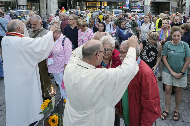 Married and same-sex couples take part in a public blessing ceremony in front of the Cologne Cathedral in Cologne, Germany, on Sept. 20, 2023. Pope Francis has formally approved allowing priests to bless same-sex couples, with a new document released Dec. 18, 2023, explaining a radical change in Vatican policy by insisting that people seeking God’s love and mercy shouldn’t be subject to “an exhaustive moral analysis” to receive it. (AP Photo/Martin Meissner, File)