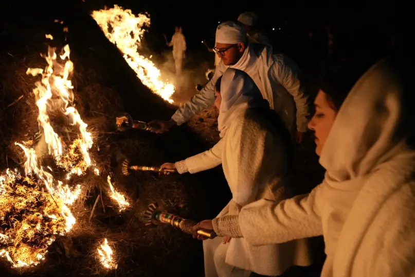 Iranian Zoroastrian youth set fire to a prepared pile of wood in a ceremony celebrating their ancient mid-winter Sadeh festival in the outskirts of Tehran, Iran, Tuesday, Jan. 30, 2024. (AP Photo/Vahid Salemi)
