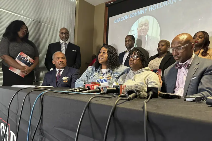 Anitra Hollman, seated second from left, speaks during a news conference announcing a lawsuit over the death of her father, Johnny Hillman in Decatur, Ga., Thursday, Jan. 18, 2024. (AP Photo/Sudhin Thanawala)