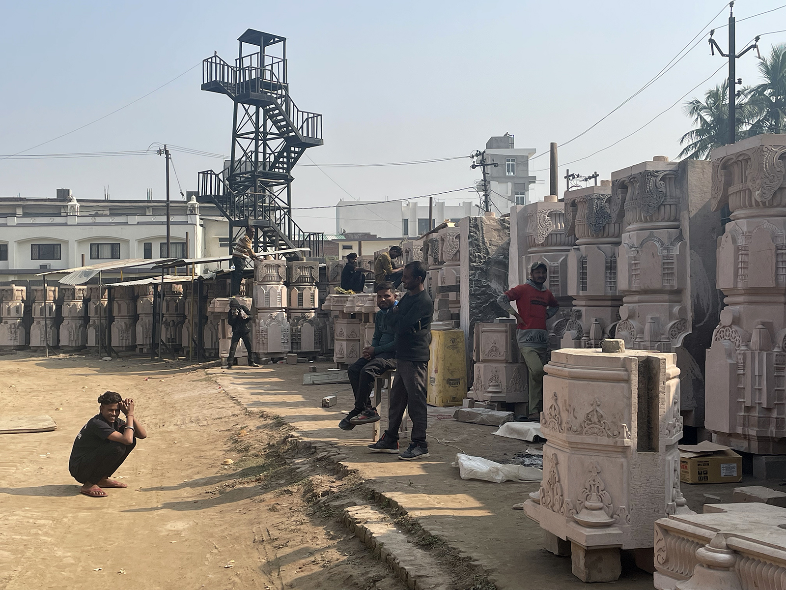 Laboreres work on stones that will eventually be used in construction at the new Ram Mandir, at a karyashala, in Ayodhya, India. (RNS photo/Richa Karmarkar)