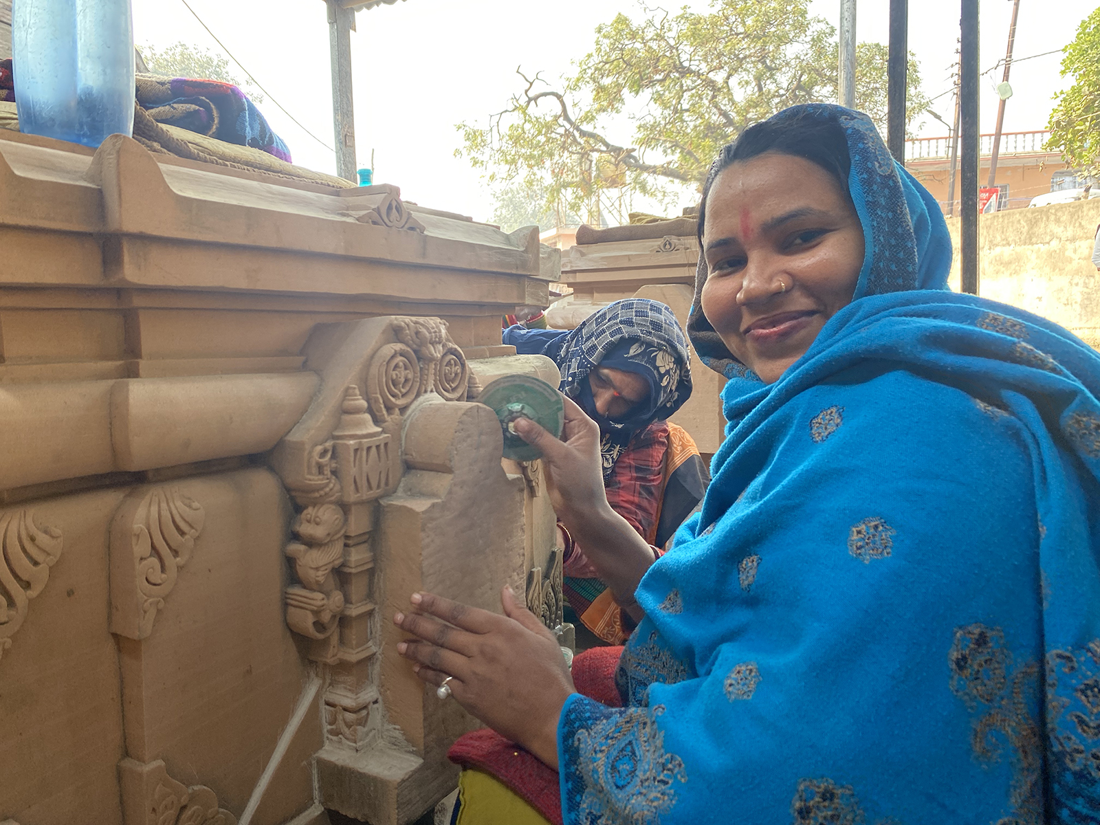 Sapna Sahu pauses from polishing stones at a karyashala in Ayodhya, India. (RNS photo/Yashraj Sharma)