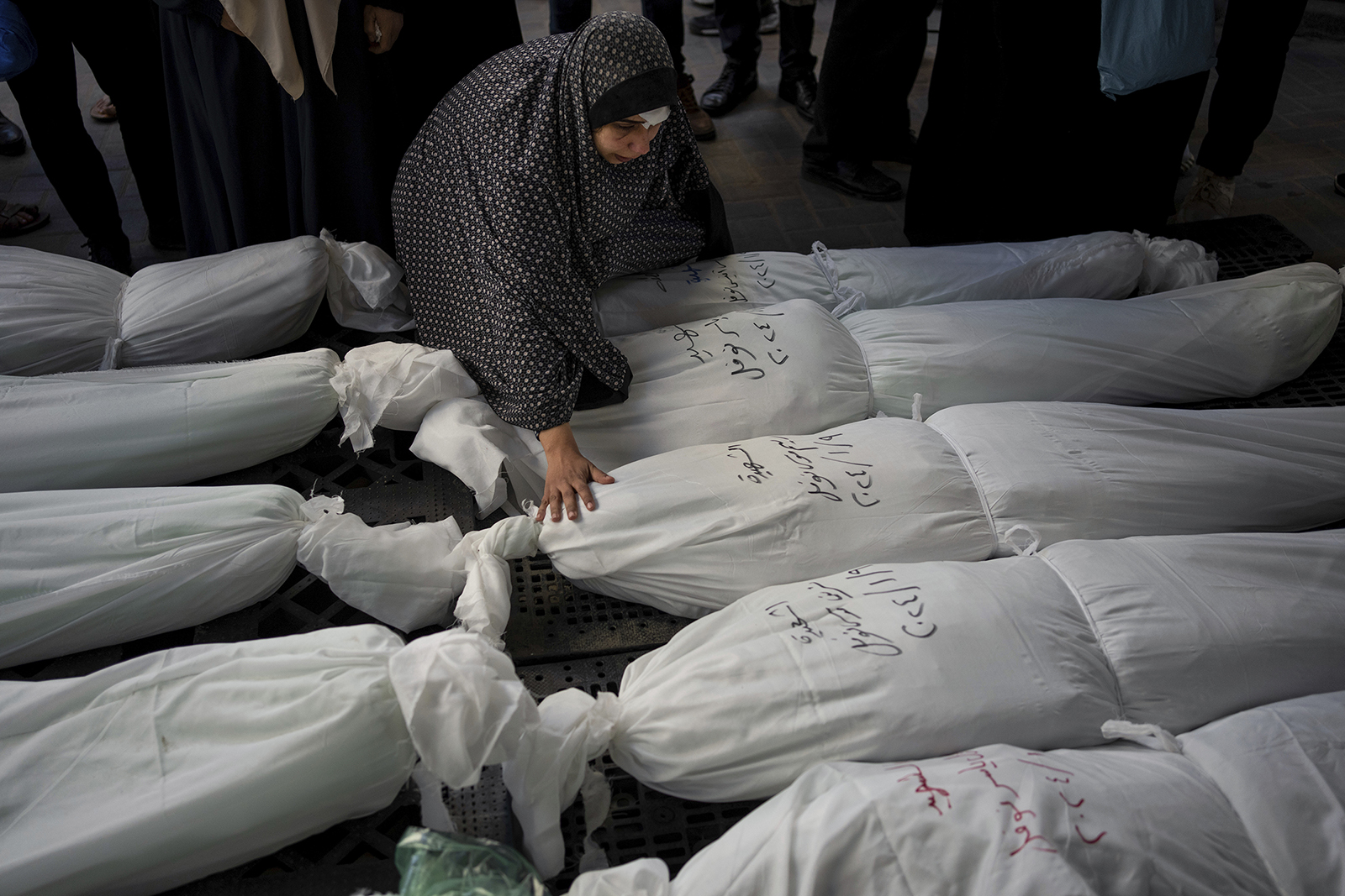 Palestinians mourn their relatives killed in the Israeli bombardment of the Gaza Strip, outside a morgue in Rafah, southern Gaza, Jan. 10, 2024. (AP Photo/Fatima Shbair)