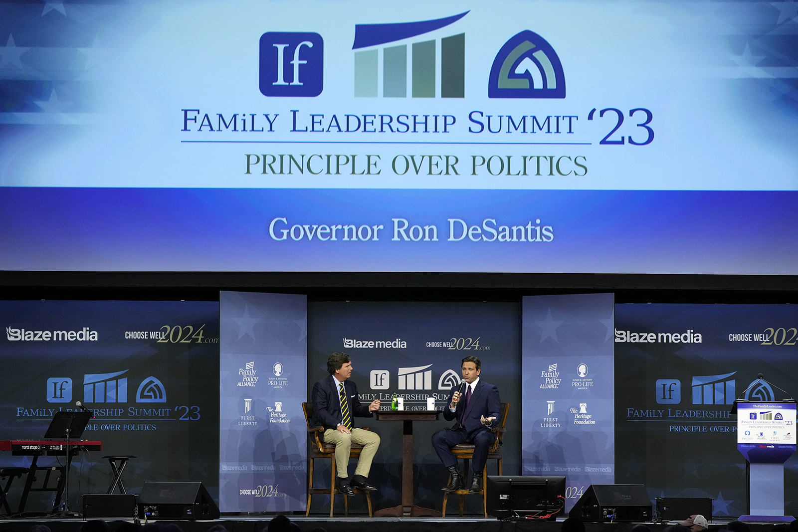 Republican presidential candidate Florida Gov. Ron DeSantis speaks with moderator Tucker Carlson, left, during the Family Leadership Summit, Friday, July 14, 2023, in Des Moines, Iowa. (AP Photo/Charlie Neibergall)
