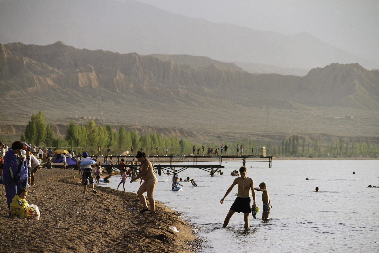 People visit a beach on the southern shore of Issyk Kul, near theManzhyly-Ata sacred springs area, in Kyrgyzstan. (Photo by Maxim Van den Bossche/Wikipedia/Creative Commons)