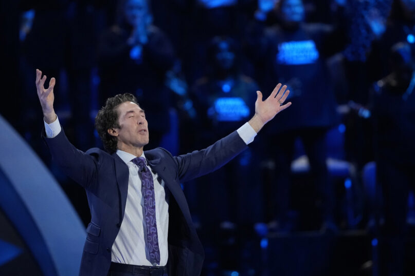 Pastor Joel Osteen prays during a service at Lakewood Church Sunday, Feb. 18, 2024, in Houston. Osteen welcomed worshippers back to Lakewood Church for the first time since a woman with an AR-style opened fire in between services at his Texas megachurch last Sunday. (AP Photo/David J. Phillip)