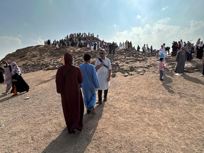 Taruj Ali, facing camera, gives a brief history lesson to his children on the Battle of Uhud, which Muslims lost in the early days of Islam, as the Ali family walks toward the place where the archers stood in the battle, during the family’s visit to Medina. (Photo by Dilshad Ali)