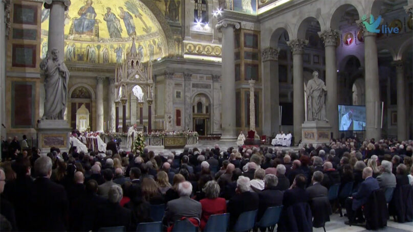 Cardinal Matteo Zuppi, center left at podium, speaks during a Mass celebrating the 56th anniversary of the lay Catholic movement of Sant'Egidio, Thursday, Feb. 8, 2024, at the Basilica of St. Paul Outside the Walls, in Rome. (Video screen grab)