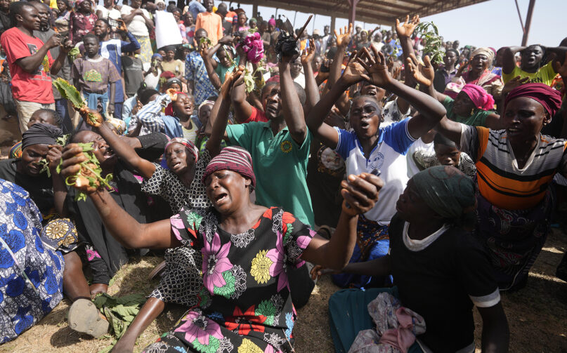 Victims of a gunmen attack react at the internal displaced camp upon the arrival of Nigeria Vice President Kashim Shettima, in Bokkos, north central Nigeria, Wednesday, Dec. 27, 2023. Nigerian officials and survivors say almost 200 people were killed by gunmen in weekend attacks on remote villages in north-central Nigeria’s Plateau state. (AP Photo/Sunday Alamba)