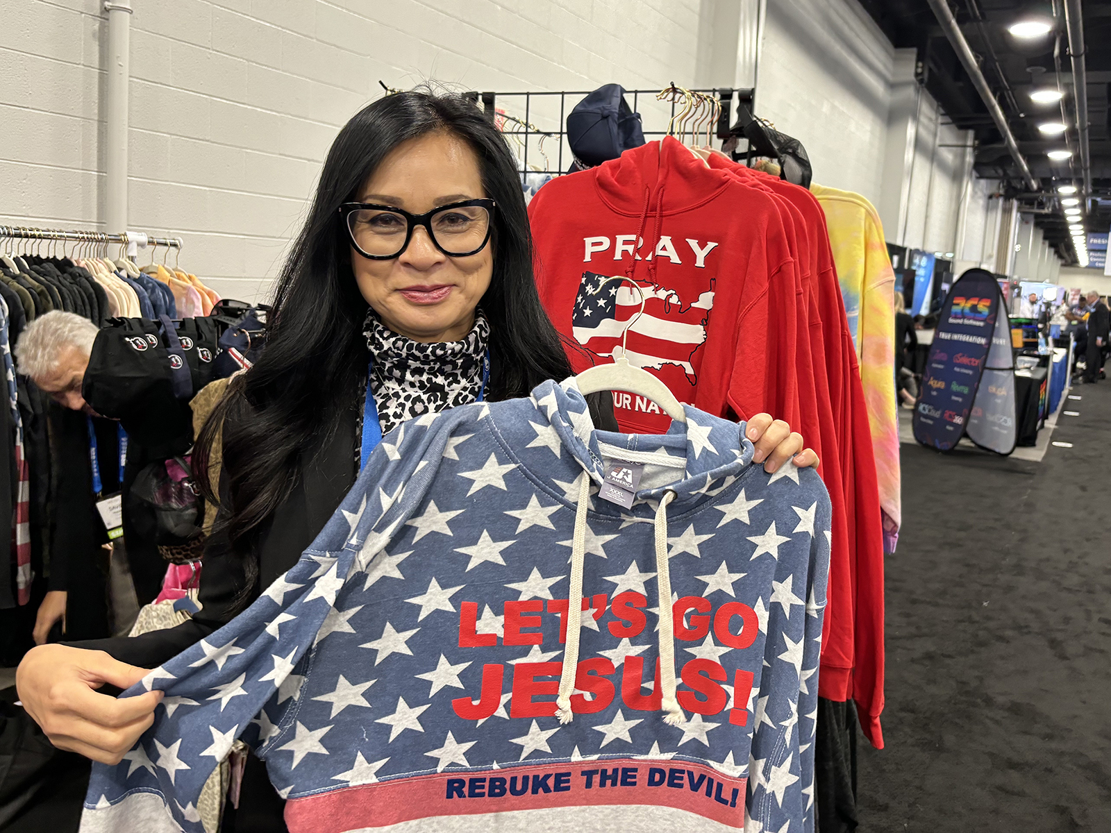 Analia Anderson displays some of her "Let's Go Jesus" merchandise in the exhibition hall of the annual gathering of National Religious Broadcasters in Nasvhille, Tenn. (RNS photo/Bob Smietana)