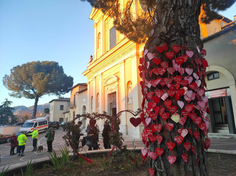 Hearts with messages cover a tree outside the Basilica of St. Valentine in Terni, Italy, on Feb. 13, 2024. (RNS photo/Claire Giangravé)