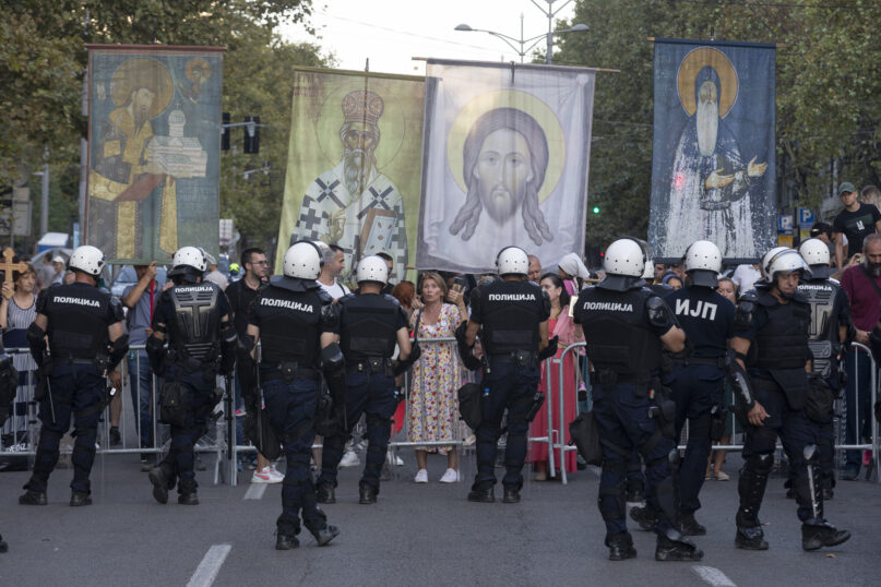 FILE - Anti-gay protesters hold religious banners amid heavy police presence and during a Pride march in Belgrade, Serbia, Saturday, Sept. 9, 2023. Greece is becoming the first majority-Orthodox Christian nation to legalize same-sex marriage. At least for the near future, it will be the only one. The Eastern Orthodox leadership, despite lacking a single doctrinal authority like a pope, has been unanimous in opposing recognition of same-sex relationships. (AP Photo/Marko Drobnjakovic, File)