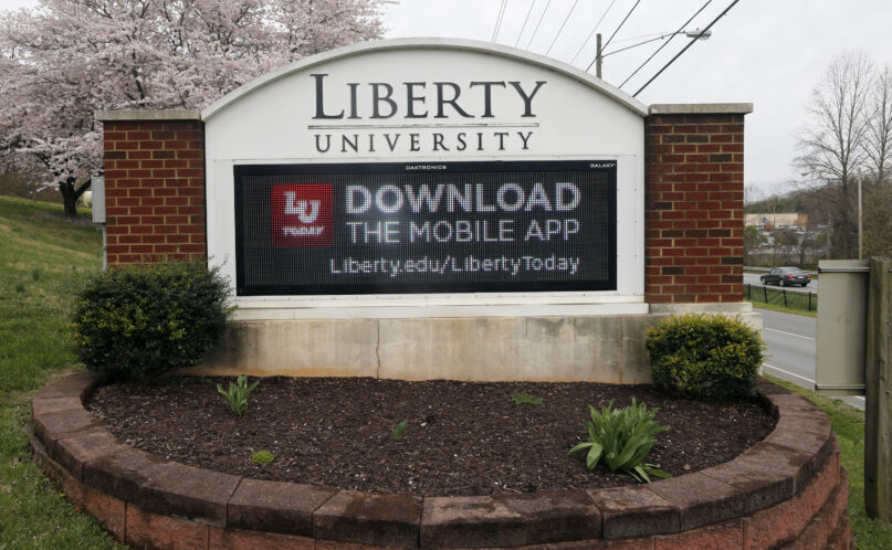 FILE - A sign marks the entrance to Liberty University, March 24, 2020, in Lynchburg, Va. Liberty University has agreed to pay an unprecedented $14 million fine after the Christian school failed to disclose information about crimes that occurred on its Lynchburg campus, including those involving sexual assaults, the U.S. Department of Education announced Tuesday, March 5, 2024. (AP Photo/Steve Helber, File)