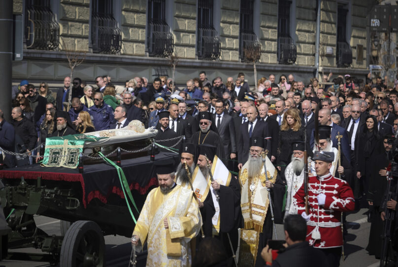 Orthodox clergy, official, honour guards and people walk along with the coffin of the Bulgarian Patriarch Neophyte during his funeral with honours procession, in Sofia, Saturday, March 16, 2024. Bulgarians have lined the streets of Sofia to bid farewell to the late Orthodox Patriarch Neophyte. The spiritual leader of Bulgaria’s Orthodox Christians died on Wednesday at the age of 78 after a long illness. Neophyte, who became patriarch in 2013, was the first elected head of the Bulgarian church after the fall of communism in 1989. (AP Photo/Valentina Petrova)