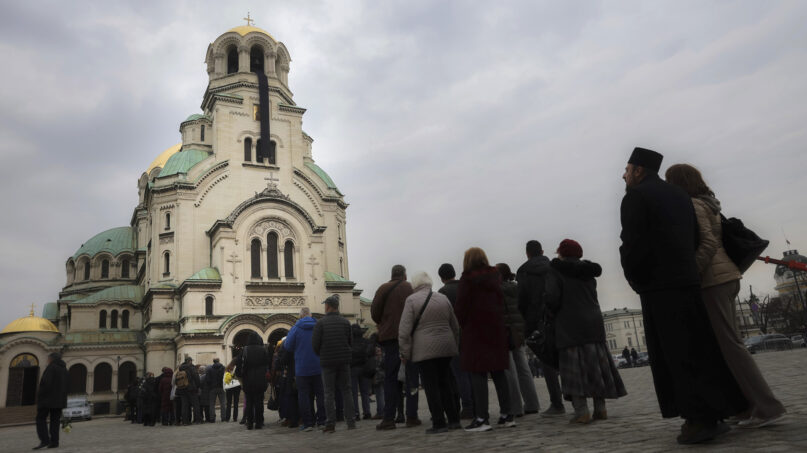 Bulgarian Orthodox believers wait in line to pay their last respects to Bulgarian patriarch Neophyte I at the Alexander Nevsky Cathedral in Sofia, Friday, March 15, 2024. (AP Photo/Valentina Petrova)