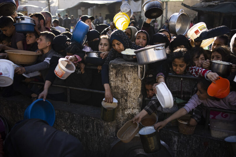 Palestinians line up for a free meal in Rafah, Gaza Strip, on Tuesday, March 12, 2024. (AP Photo/Fatima Shbair)