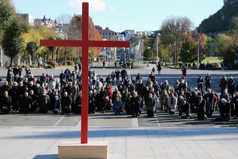 FILE - Bishops kneel on the forecourt of the Notre-Dame-du-Rosaire basilica in the sanctuary of Lourdes, southwestern France, Saturday, Nov. 6, 2021. More than 500 victims of child sexual abuse by priests or other church representatives have received financial compensation from France’s Catholic Church under a sweeping reparations program, the independent body in charge of the process said Thursday March 14, 2024. (AP Photo/Bob Edme, File)
