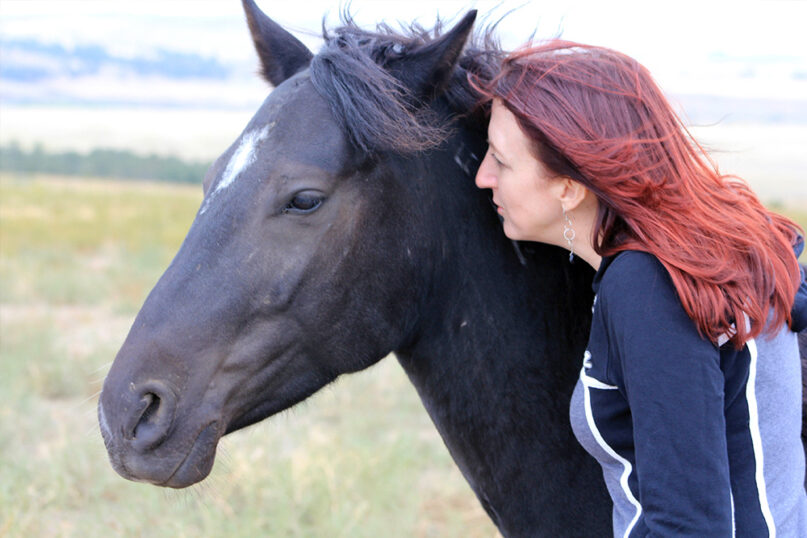 Animal chaplain Sarah Bowen interacts with a horse. (Photo by Sean Bowen)