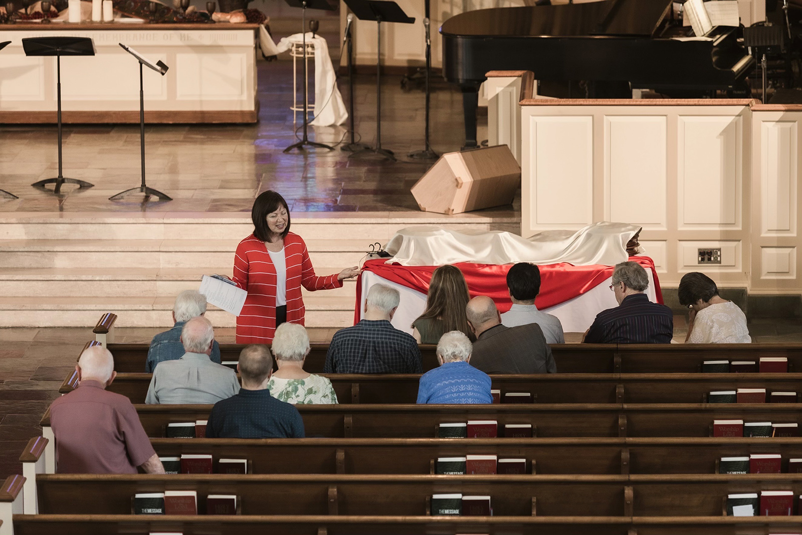 The Rev. Carma Wood, top left, leads communion server preparation at Park Place Church of God in Anderson, Indiana, prior to her retirement. (Photo by Kim Butler)