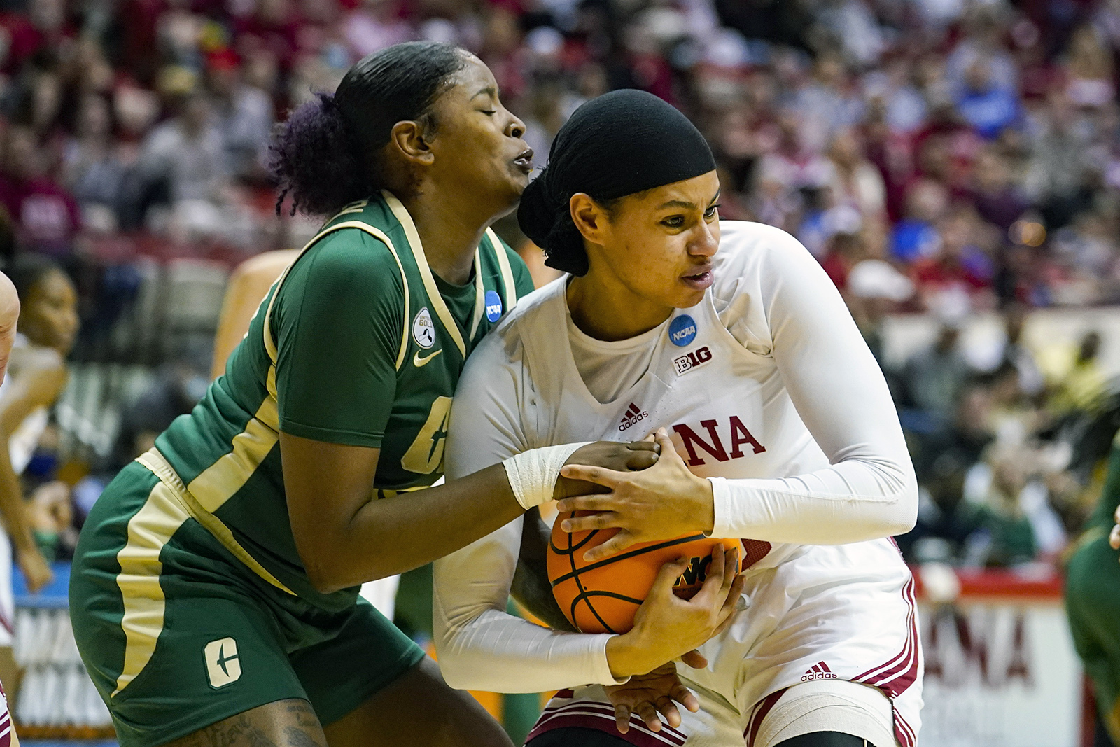 Indiana forward Kiandra Browne, right, gets tied up by Charlotte forward KeKe McKinney, left, in the first half of a college basketball game in the first round of the NCAA tournament in Bloomington, Ind., Saturday, March 19, 2022. (AP Photo/Michael Conroy)