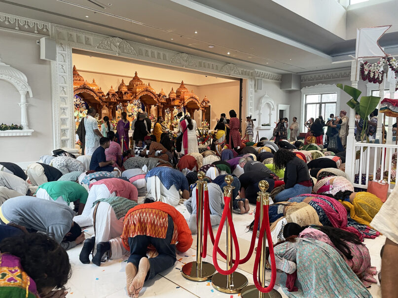 Attendees bow in prayer to the deities after their unveiling at the newly built temple. The new space covers more than 4,000 sq ft. RNS photo by Richa Karmarkar