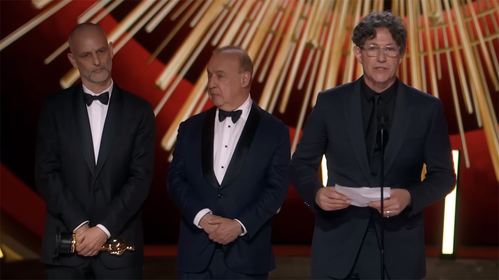 Director Jonathan Glazer, right, gives an acceptance speech after “The Zone of Interest” won the Oscar for best international feature. (Video screen grab via ABC)
