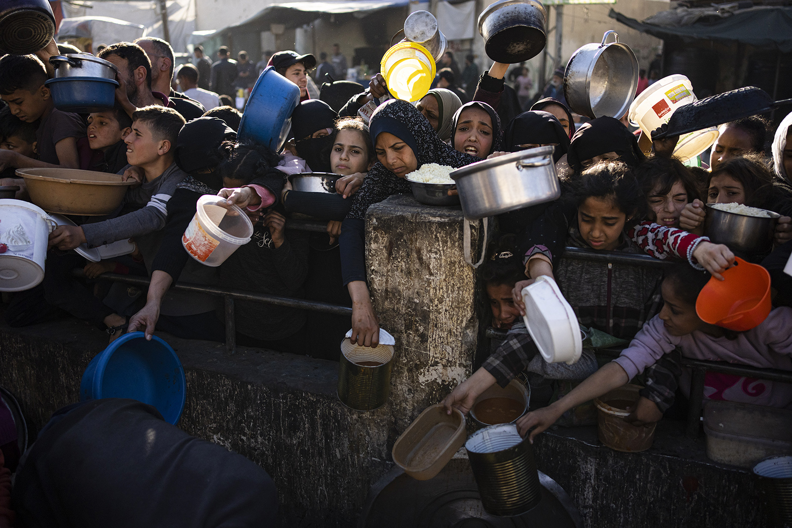 Palestinians line up for a free meal in Rafah, Gaza Strip, on March 12, 2024. (AP Photo/Fatima Shbair)