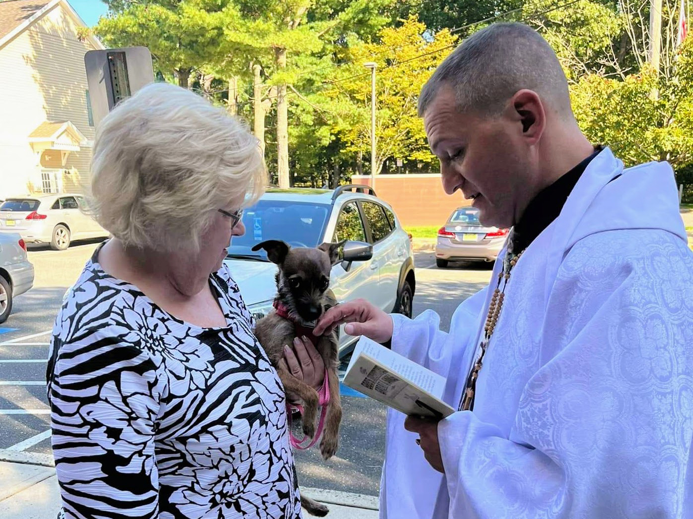 Chaplain Matty Giuliano speaks with a dog and its owner. (Courtesy photo)