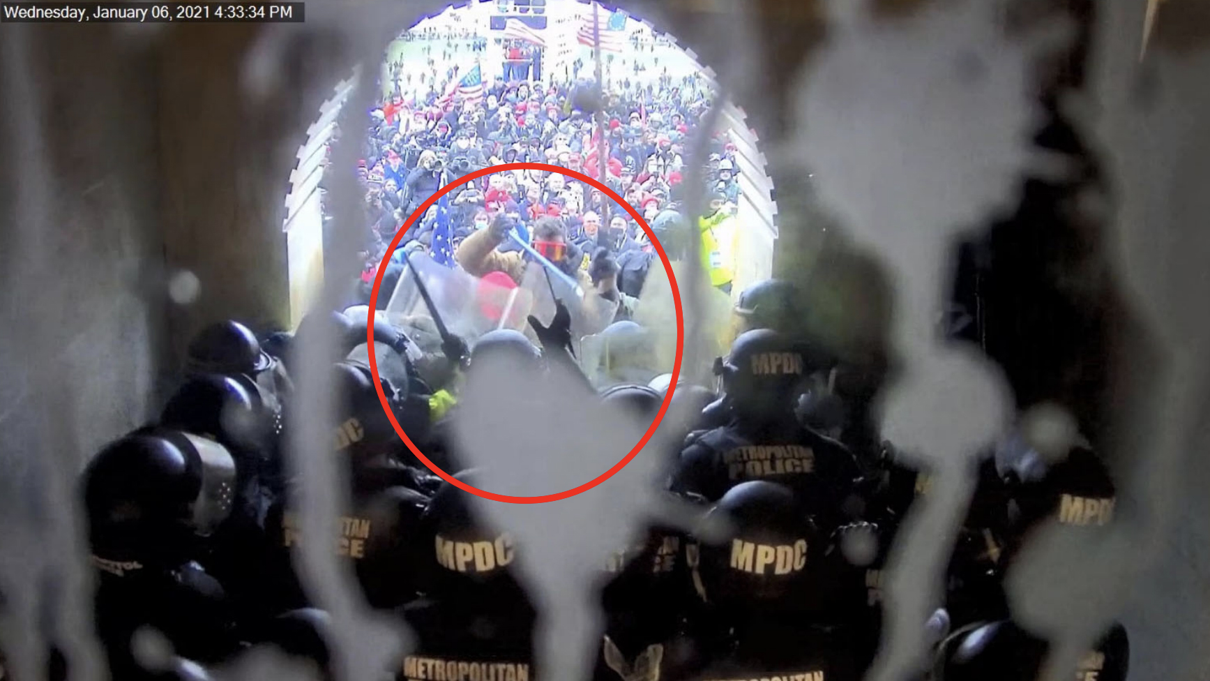 Photo evidence of Scott Miller, circled, hitting Capitol police officers with a pole on Jan. 6, 2021. (Photo via U.S. government sentencing memorandum)