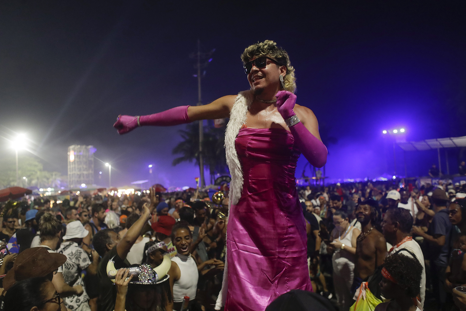 A fan dances while waiting for the start of Madonna's last show of her The Celebration Tour, on Copacabana beach in Rio de Janeiro, Brazil, Saturday, May 4, 2024. (AP Photo/Bruna Prado)