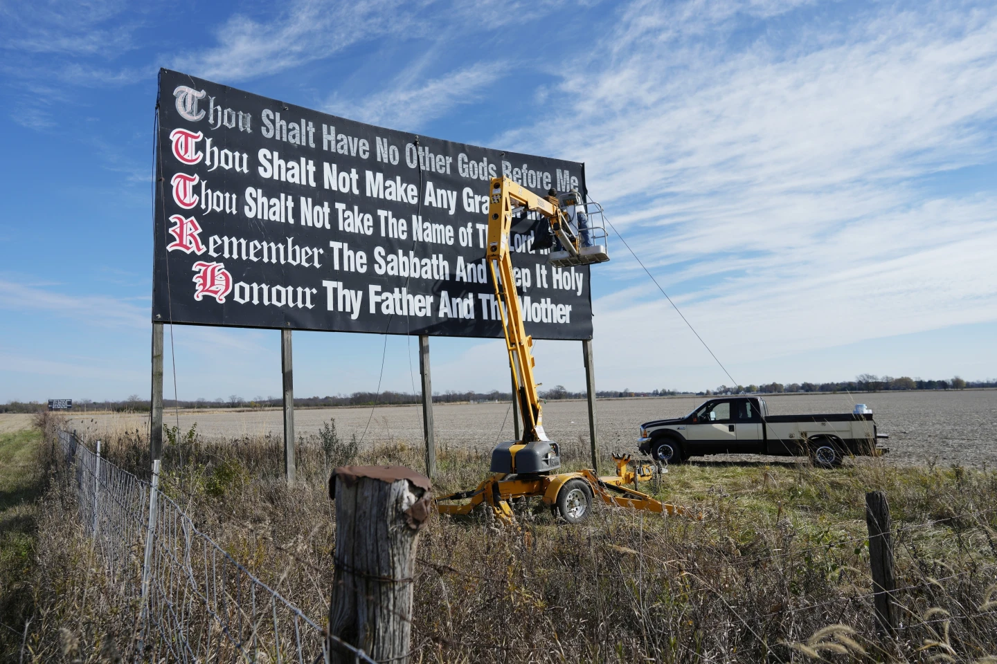 Workers repaint a Ten Commandments billboard off of Interstate 71 on Election Day near Chenoweth, Ohio, Nov. 7, 2023. Louisiana has become the first state to require that the Ten Commandments be displayed in every public school classroom under a bill signed into law by Republican Gov. Jeff Landry on Wednesday. (AP Photo/Carolyn Kaster, File)