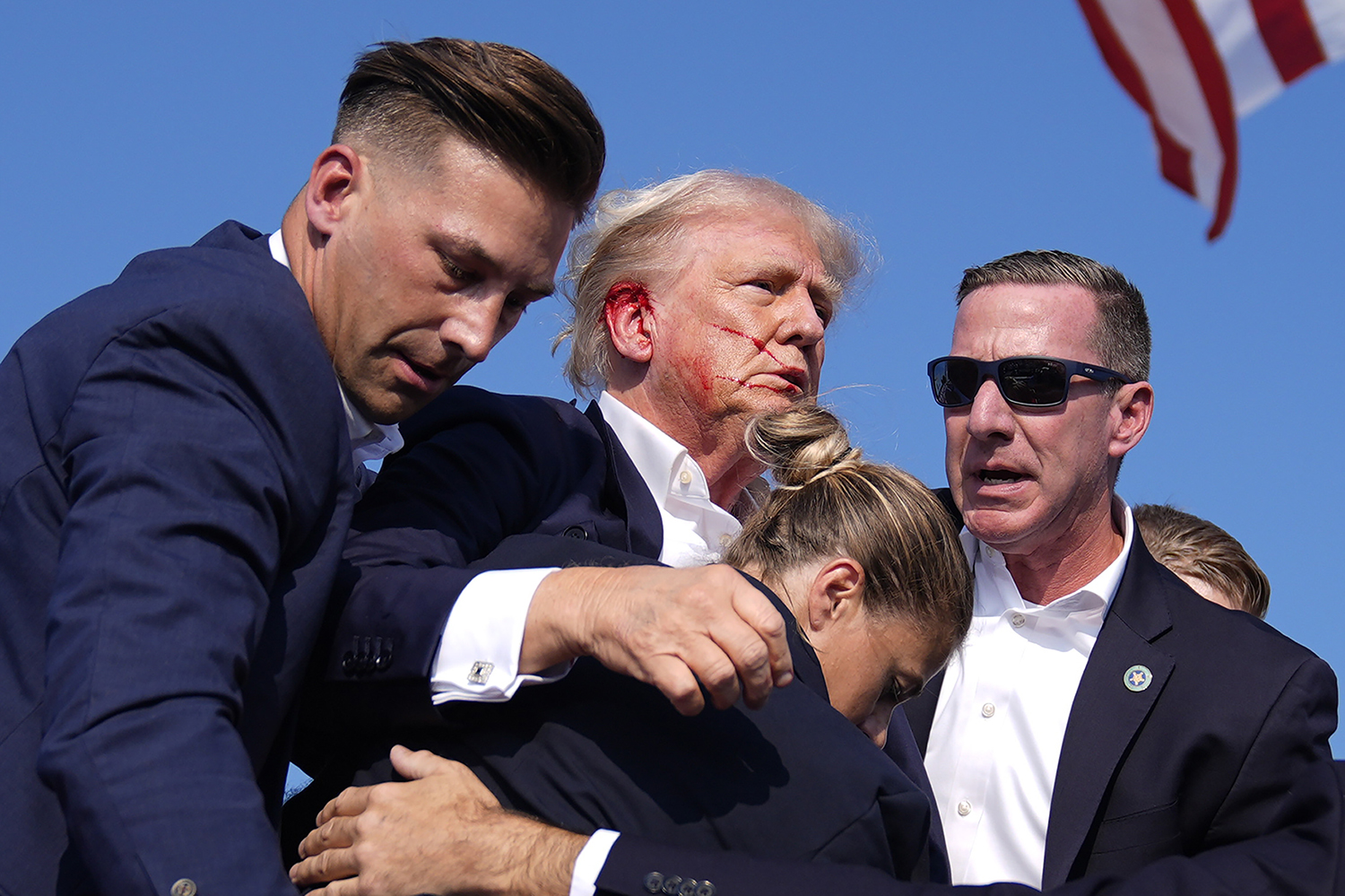 Republican presidential candidate former President Donald Trump gestures as he is surrounded by U.S. Secret Service agents at a campaign rally, Saturday, July 13, 2024, in Butler, Pa. (AP Photo/Evan Vucci)