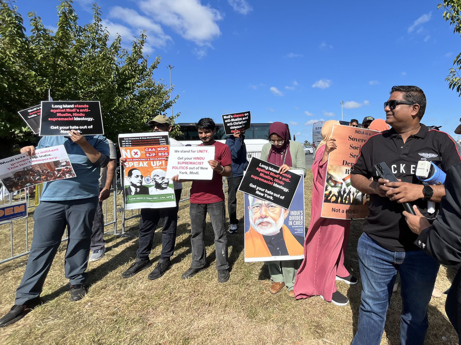 Acitivits of various faith backgrounds hold signs protesting Narendra Modi, outside the Nassau Veterans Memorial Colisieum in Uniondale, N.Y., Sunday, Sept. 22, 2024. (Photo by Rohan Narine/Hindus for Human Rights)