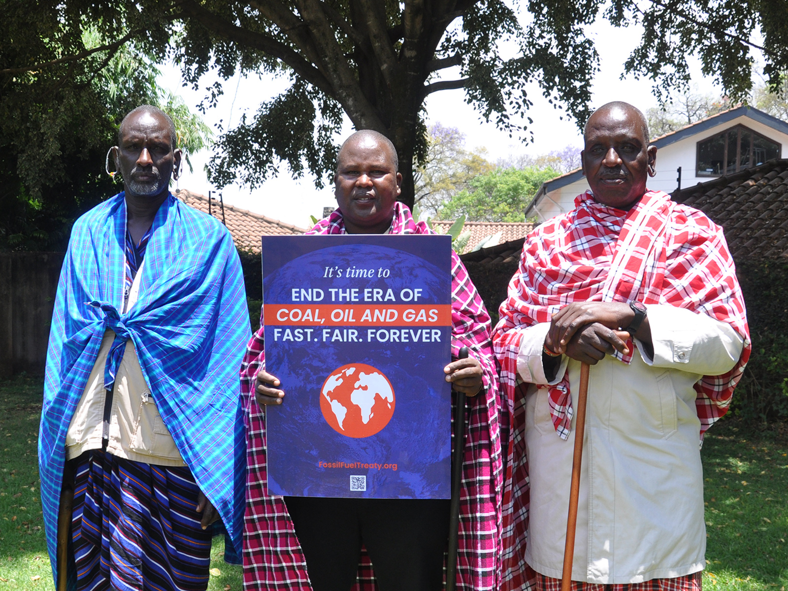 Maasai elders Santomu Sitonik, from left, Moses Kipaliash and Nchooka Meruoyo pose with a poster during an interfaith media briefing on fossil fuels in Nairobi, Kenya, on Friday, Sept, 20, 2024. (Photo by Fredrick Nzwili)