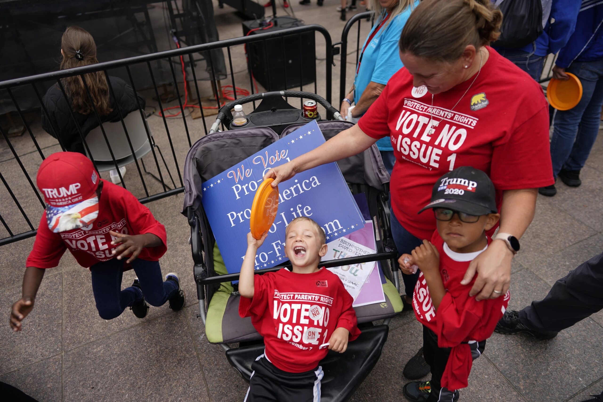 The Young children from left, Gianna, Isaac, and Lucas, attend the Ohio March for Life, with their mom Erin Young, right, at the Ohio Statehouse in Columbus, Ohio, Friday, Oct. 6, 2023. All three children are adopted.