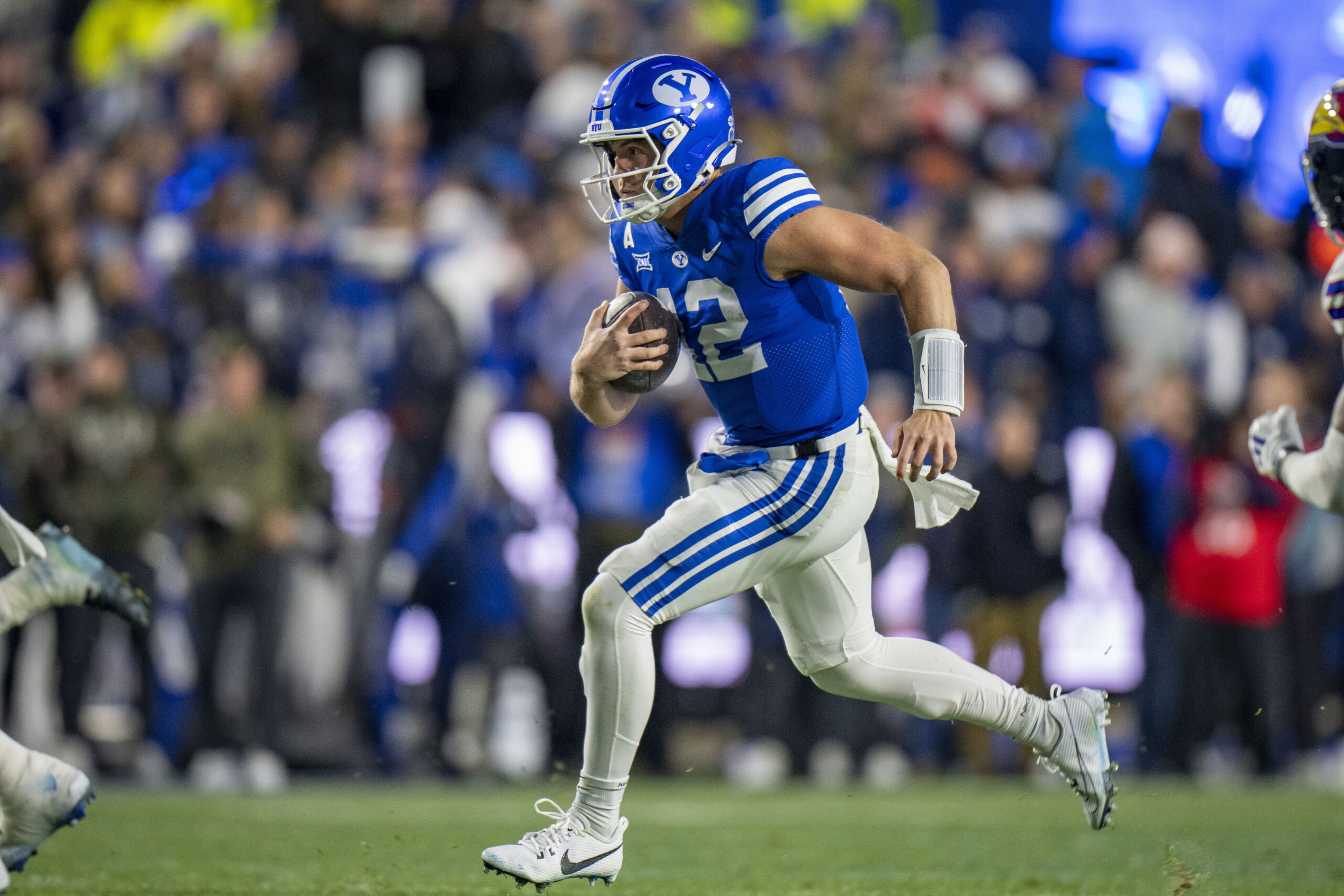 BYU quarterback Jake Retzlaff runs on a quarterback keeper, during the first half of an NCAA college football game Saturday, Nov. 16, 2024, in Provo.