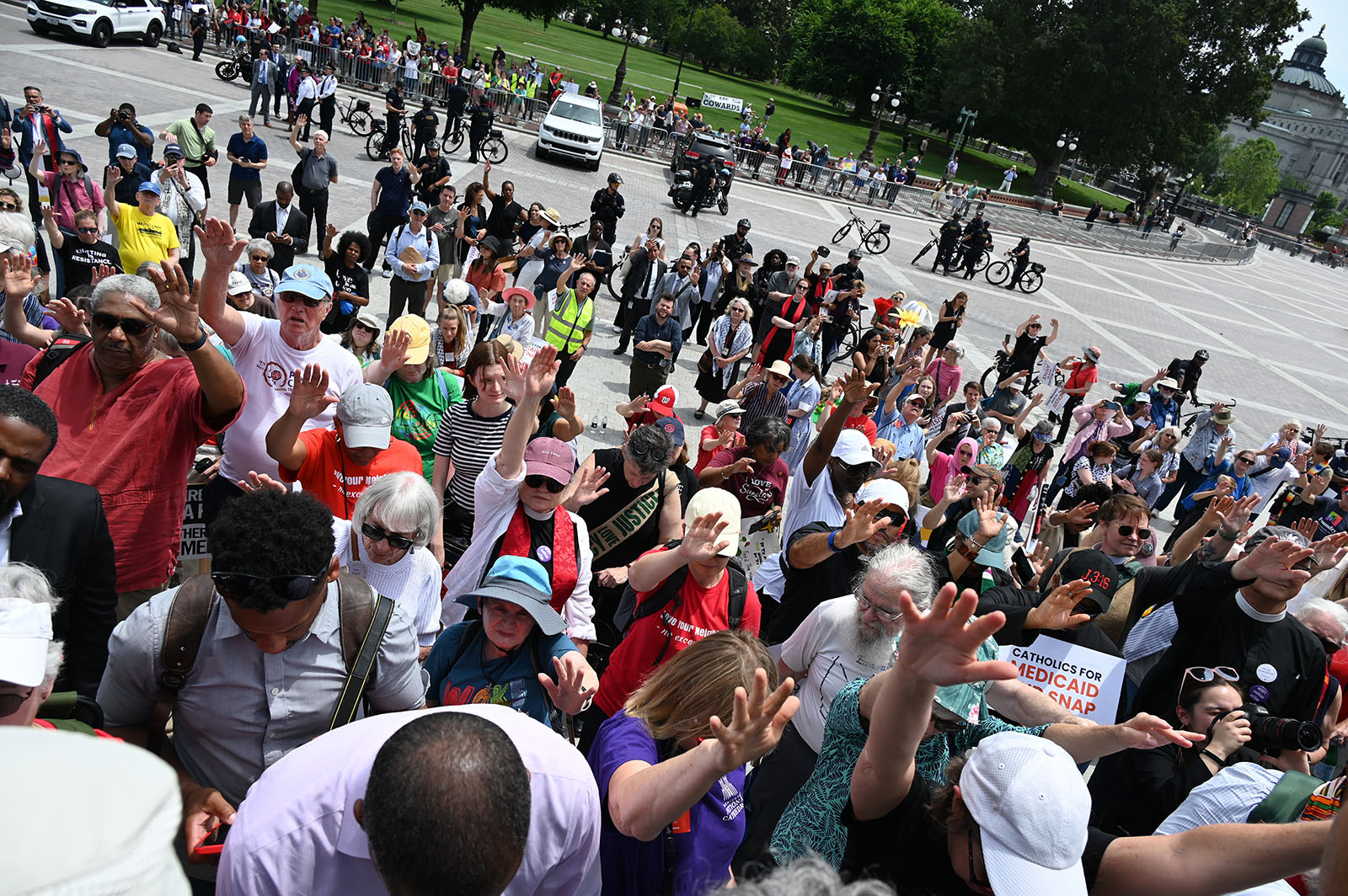 Demonstrators pray on the steps of the U.S. Capitol during a rally against the “One Big Beautiful Bill Act,” June 10, 2025. (RNS photo/Jack Jenkins)