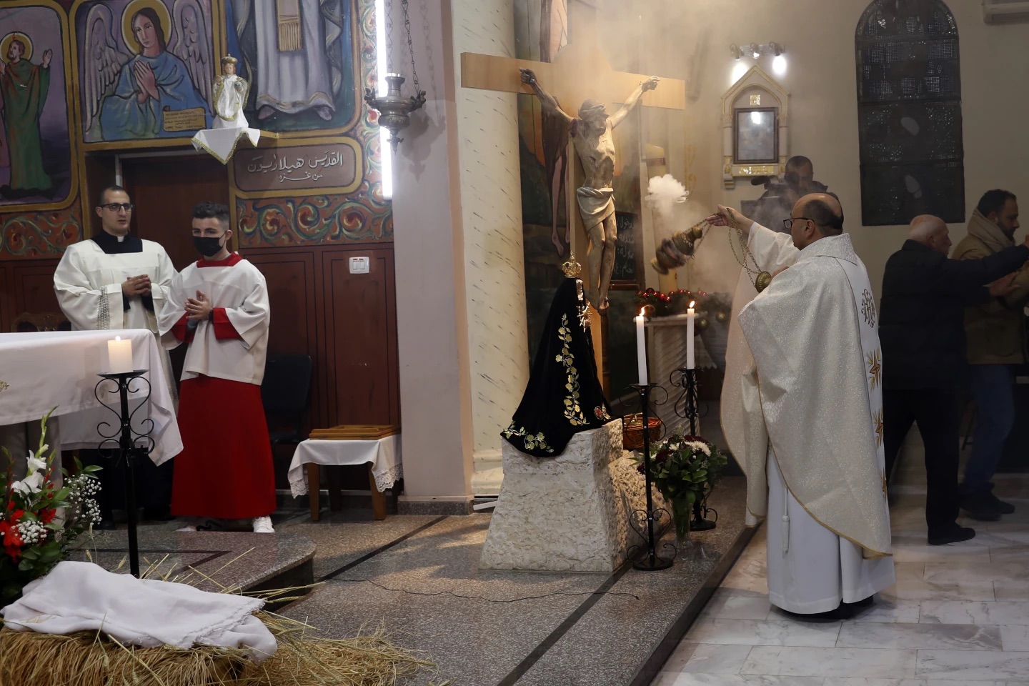 priests praying catholic church Gaza