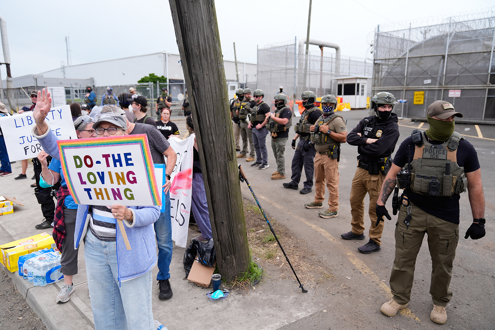 Masked federal agents stand outside the Delaney Hall detention center during a protest against the transfer of detainees, May 27, 2026, in Newark, N.J. (AP Photo/Seth Wenig)