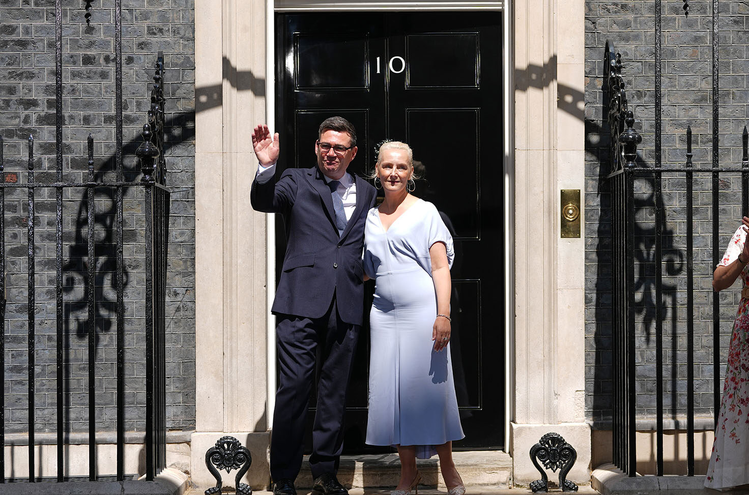 Britain's new prime minister, Andy Burnham, and his, wife Marie-France van Heel, wave as they arrive at 10 Downing Street in London, Monday, July 20, 2026.(AP Photo/Kirsty Wigglesworth)