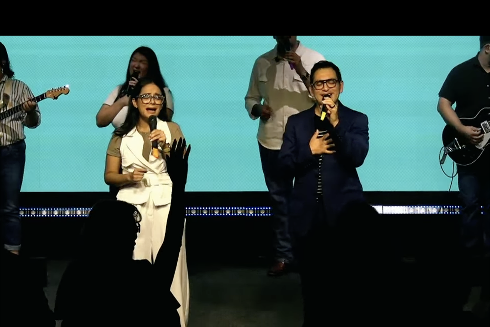 After being released from immigration detention, pastors Cinthia Sarai Cardona Otero, left, and Nepthali Zozaya Saucedo sing in front of their congregation on Sunday, July 27, 2026, at Comunidad Cristiana Emanuel in Edinburg, Texas.  (Video screenshot)
