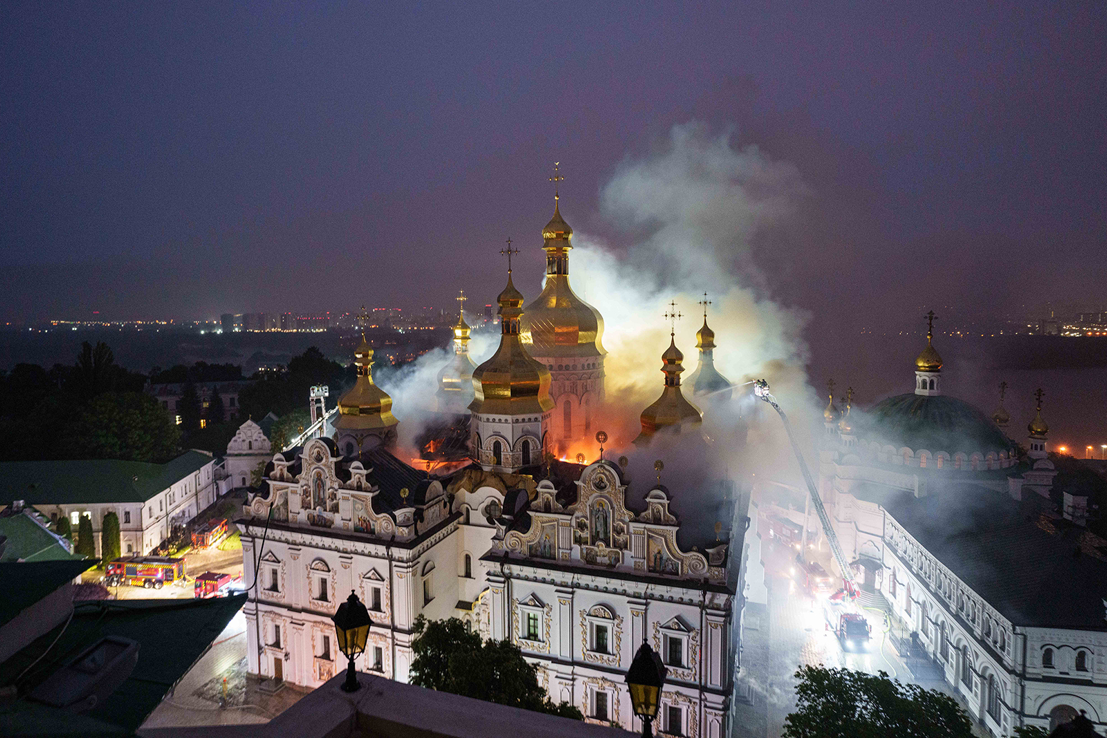 Rescue workers try to put out a fire at the Dormition Cathedral of thousand-year-old Monastery of Caves, also known as Kyiv Pechersk-Lavra, following a Russian strike on Kyiv, Ukraine, Monday, June 15, 2026. (AP Photo/Evgeniy Maloletka)
